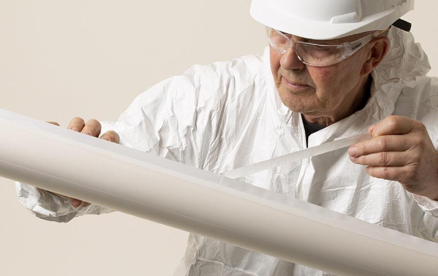 Person removing tape backing liner