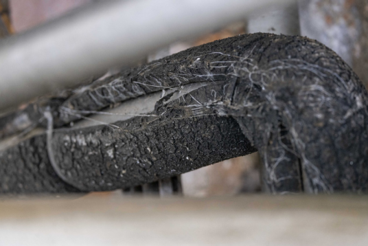 Damaged elastomeric foam insulation on pipework.